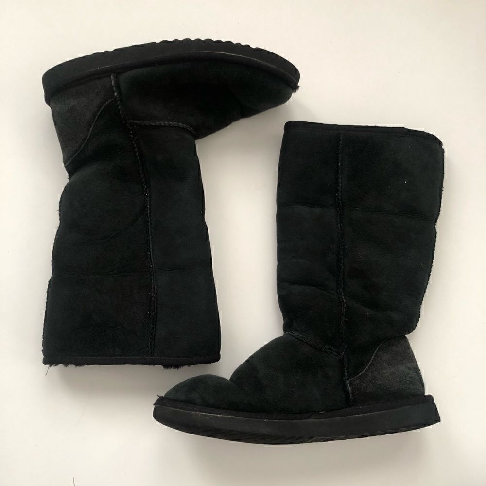 Ugg’s classic tall boots in black shearling lined
